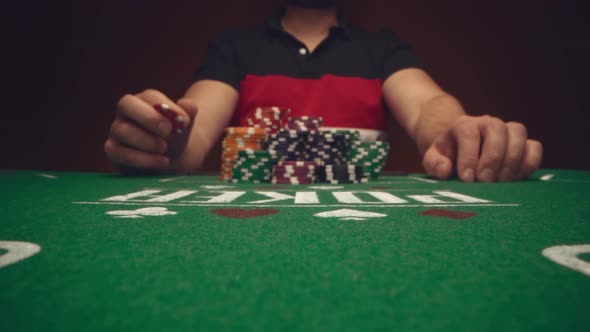 Male Player Betting All Chips in While Playing in Casino Close Up