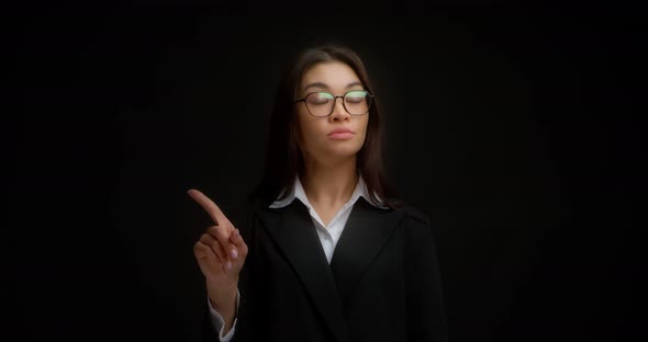 Portrait of Serious Young Businesswoman Raising Forefinger Up Saying No