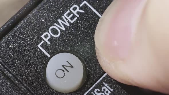 Caucasian Male Hand Holding the TV Remote Control and Turning Smart Tv on or Off alt