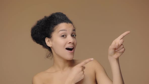 Beauty Portrait of Young African American Woman Pointing Side Hand for Something Nods and Shows alt