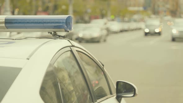 Flashing Flasher on the Roof of a Police Car. Blinker. Close-up. alt