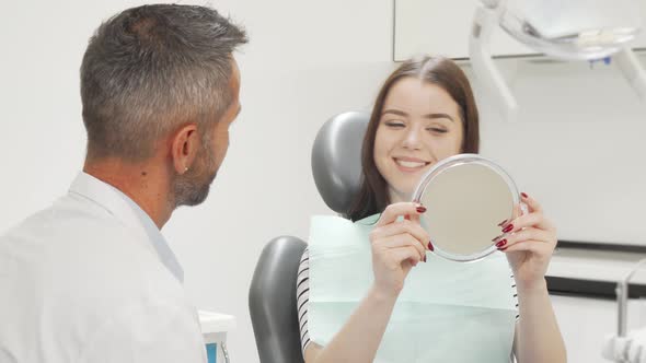 Beautiful Happy Woman Talking To the Dentist After Medical Checkup