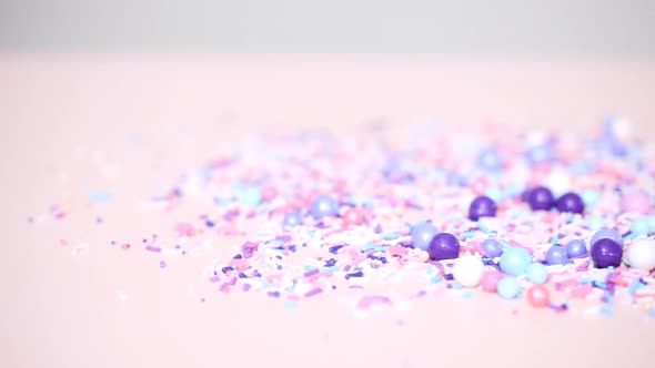 Colorful purple sprinkle blend on a pink background. alt