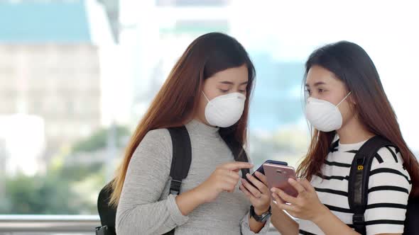 Asian teenager travelers wearing protective PM 2.5 mask  alt