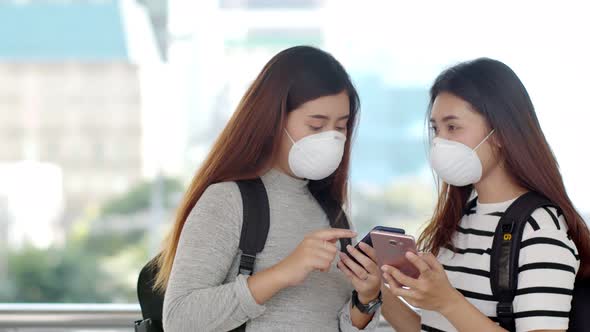 Asian teenager travelers wearing protective PM 2.5 mask 