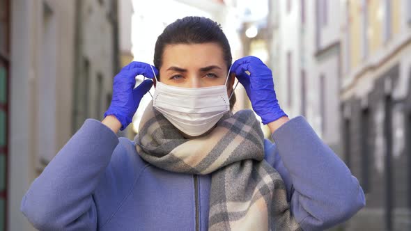 Young Woman Wearing Protective Face Mask in City alt