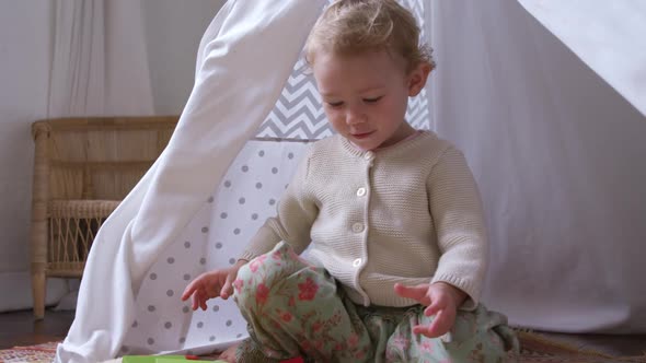 Caucasian baby playing at home alt