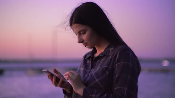 Woman Use Phone Online Internet Texting on Street Walking with Phone in Hands