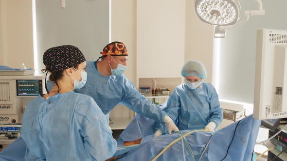 Surgeons Team Performing Operation in Hospital Operating Theater Male Surgeon alt