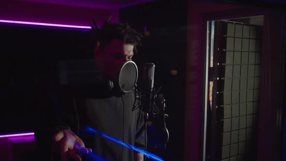 Emotional Cool Black Hip Hop Artist Rapping New Track Into Microphone in Sound Recording Studio alt