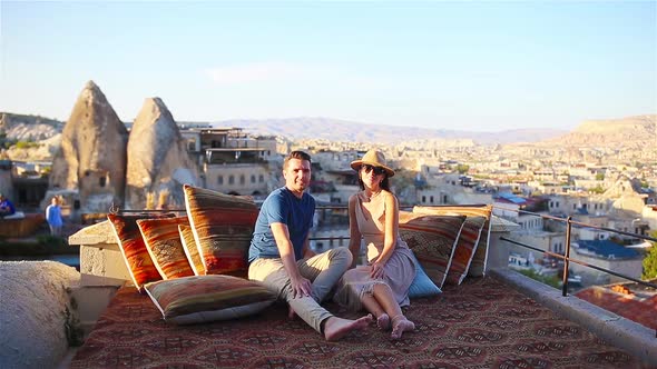 Happy Young Couple During Sunrise Watching Hot Air Balloons in Cappadocia Turkey
