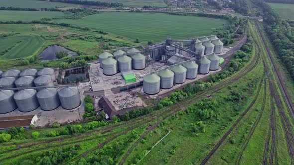 Commercial Grain Or Seed Silos In Sunny Spring Rural Landscape alt
