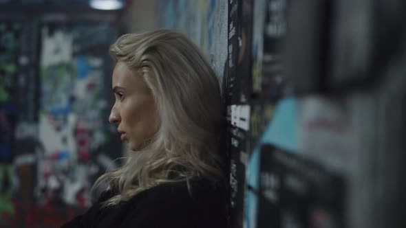 Girl Model Looking Camera with Blonde Hair at City Night Urban Background alt