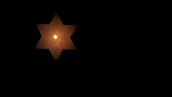 Star of David Candle on Hanukkah alt