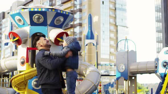 Loving Caucasian Dad Tossing Laughing Kid Up in Air alt