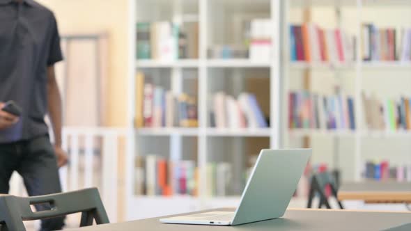 Professional African Man Coming Back and Opening Laptop alt