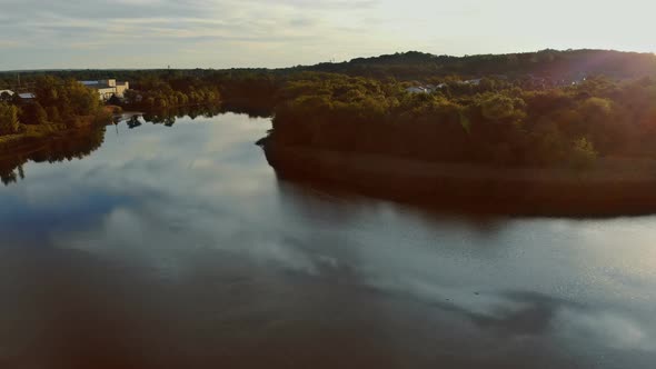 Aerial View of Town Along the River with Residential Areas of Private Houses on Colorful Clouds in alt