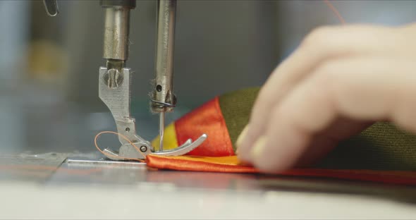 Woman Seamstress Working on an Industrial Sewing Machine. alt