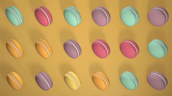 Multicolored macaron pastries on light yellow paper background