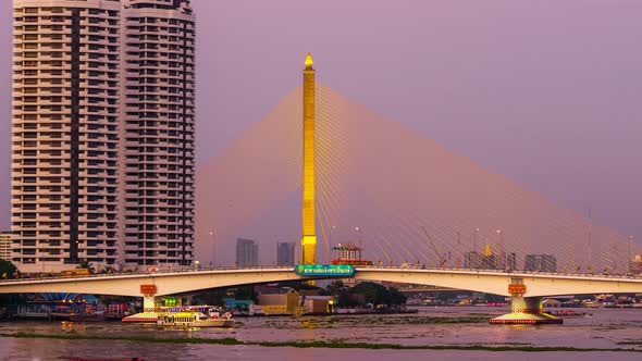 day to night time lapse of Somdet Phra Pinklao Bridge over the Chao Phraya River in Bangkok