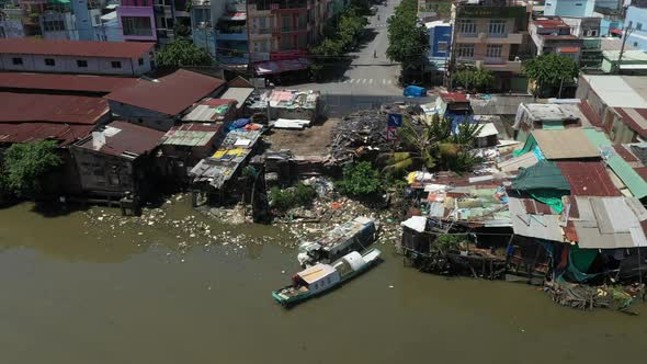Tracking drone shot of Old and new buildings along the Kenh Te Canal. This waterway connects The Mek alt