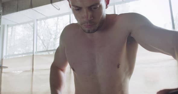 Training with Intense Cardio Bike, Exercise in Closed Gym. Men Doing Difficult Cardio Workout with alt