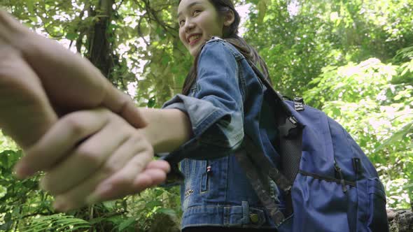 Young Woman Holding Hand Of Her Boyfriend While Hiking alt