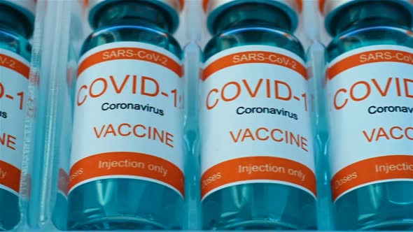 Ampoules With Covid-19 Vaccine In A Box On Conveyor.