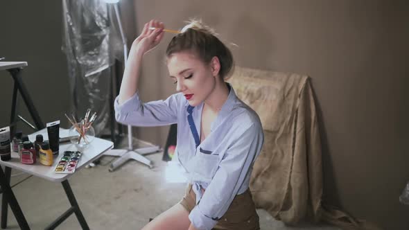 Sexy Blonde Girl Artist in Art Studio