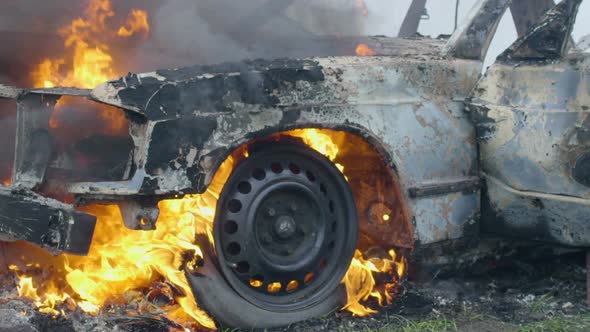Burning Car Tires, the Car Burns a Wheel, a Completely Burnt Out Car