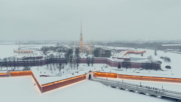Aerial Footage of the Peter and Paul Fortress in a Snow Storm in a Winter Evening Night Illumination alt