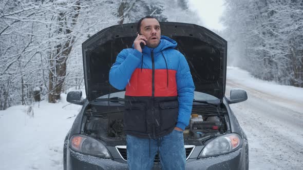 Angry Man Calls on the Phone Near the Broken Car alt