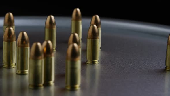 Cinematic rotating shot of bullets on a metallic surface - BULLETS alt
