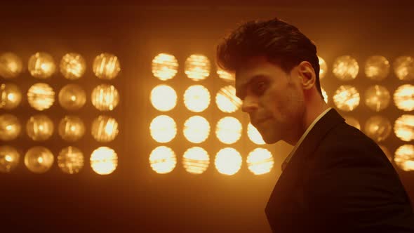 Portrait Seductive Guy Looking Camera Confidently in Nightclub Spotlight Closeup alt