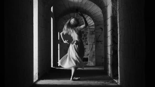 Dancing blonde woman in  dress in an old abandoned building Black and white video. alt