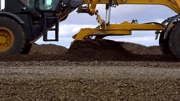 Grader Aligns and Lays the Ground on the Road alt
