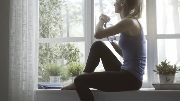 Woman exercising at home and having a break