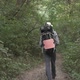 A Tourist Walks Through a Dense Green Forest - VideoHive Item for Sale