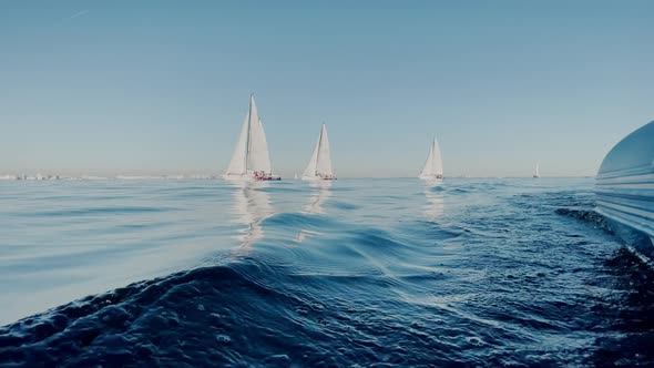 View of Sailing Race From a Judicial Rubber Motor Boat Some Sailboats in a List Goes By Sea the