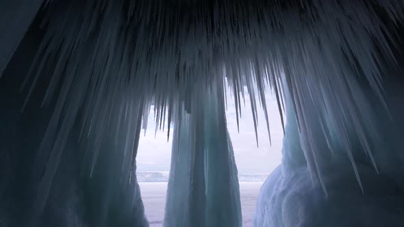 Huge Stalactites Sharp Icicles Floes Frozen Cave and Blue Ice Iceberg of Lake Baikal
