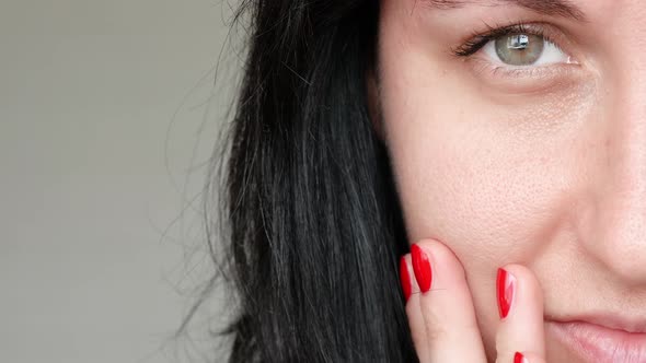Close-up of Half a Woman's Face. The Girl Examines Her Problem Skin with Dilated Pores, Touching It alt