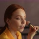 Closeup Side View of Pretty Redhead Young Woman Talking with Somebody and Making Makeup Using - VideoHive Item for Sale