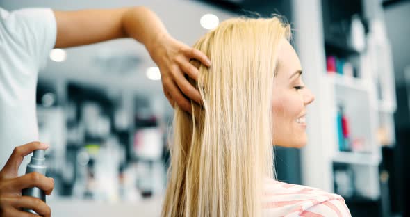 Portrait of Hairdresser Taking Care of Blonde Woman