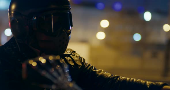 Close Up to Motorcyclist in Helmet Riding Motorbike in City with Night Lights