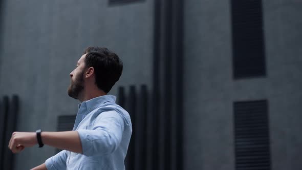 Happy Bearded Man Celebrating Victory in Downtown Area alt