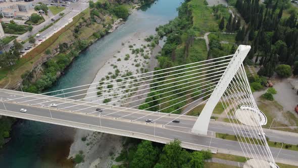 Aerial drone view of cable stayed Millennium bridge and Moraca river in Podgorica, Montenegro