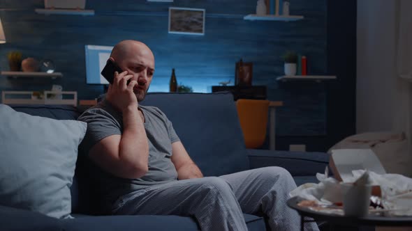 Astonished Man Talking at Phone Receving Horrible News alt