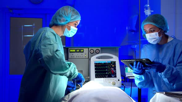 Female Medics Performing Surgery in Operating Theater