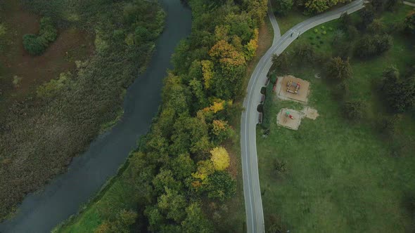 Flight over the autumn park in cloudy weather. alt