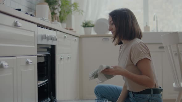 Woman Takes Cookies Out of the Oven